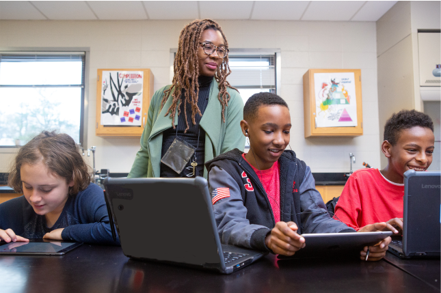 Teacher monitoring students on computers