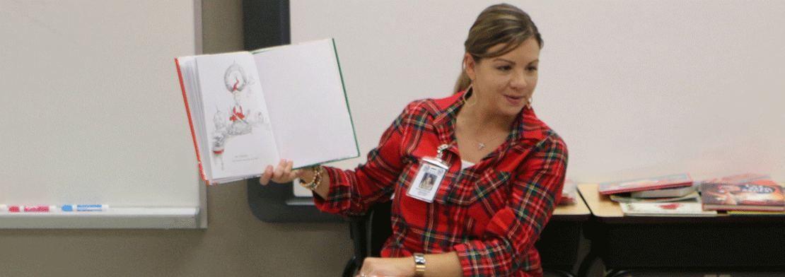 Teacher holding a book up