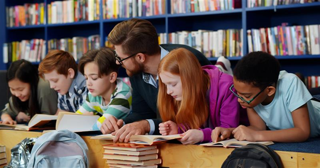 Teacher with students at a library