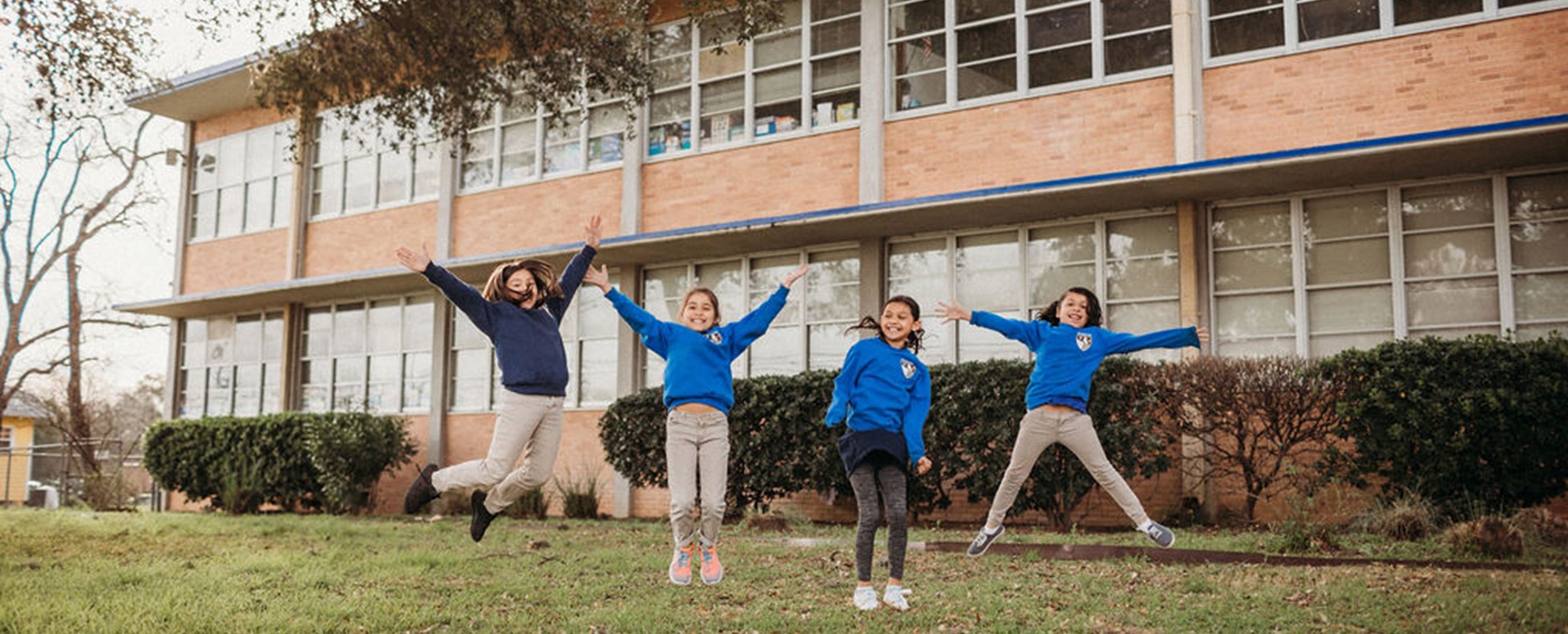 Students-jumping-outside-school